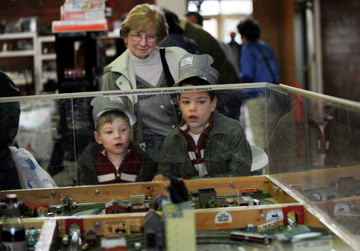 Shane Barton, 5, left, of New Fairfield, their grandmother Joan Downey of Oxford and brother Aidan, 8, look at Joel's Trainville Hobby Depot N-Scale at the Westchester Model Railroad Club's Fall Train Meet at Eastern Greenwich Civic Center Sunday, Nov. 27, 2011.