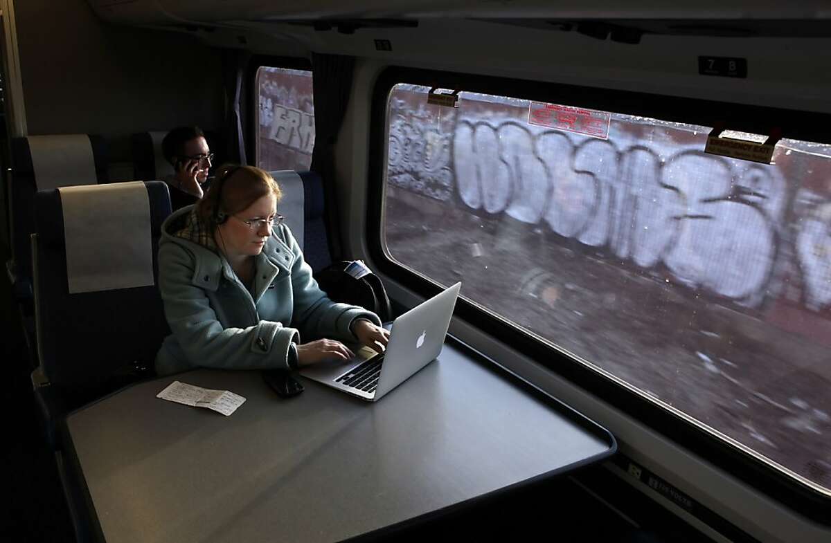 Amber Sass of Sacramento uses her laptop while on the Capitol Corridor Amtrak Train on her way home from San Francisco. While high-speed rail in California is getting all the attention, the state's lower-speed intercity trains are seeing a boom in popularity. Trains like the Capitol Corridor, shown here on Thursday, December 23, 2010, in Emeryville, Calif., have seen a double digit rise in passengers. Ran on: 01-05-2011 Amber Sass of Sacramento uses her laptop on the Capitol Corridor Amtrak Train, heading home from San Francisco. Ran on: 01-05-2011 Amber Sass of Sacramento uses her laptop on the Capitol Corridor Amtrak Train, heading home from San Francisco.