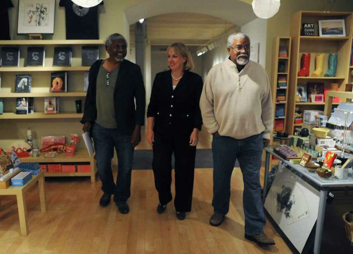 Dr. Leo Edwards, left, and his brother, Anthony Edwards, right, walk with Katie Luber, director of the San Antonio Museum of Art, in the museum's store on Thursday, Nov. 10, 2011.