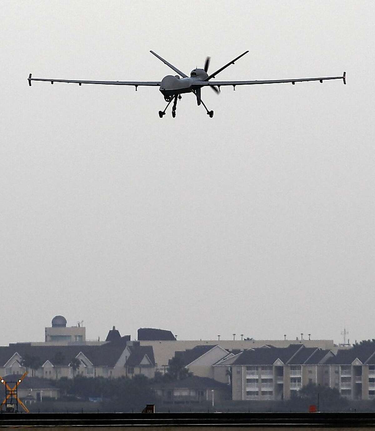 A Predator B unmanned aircraft lands after a mission at the Naval Air Station, Tuesday, Nov. 8, 2011, in Corpus Christi.