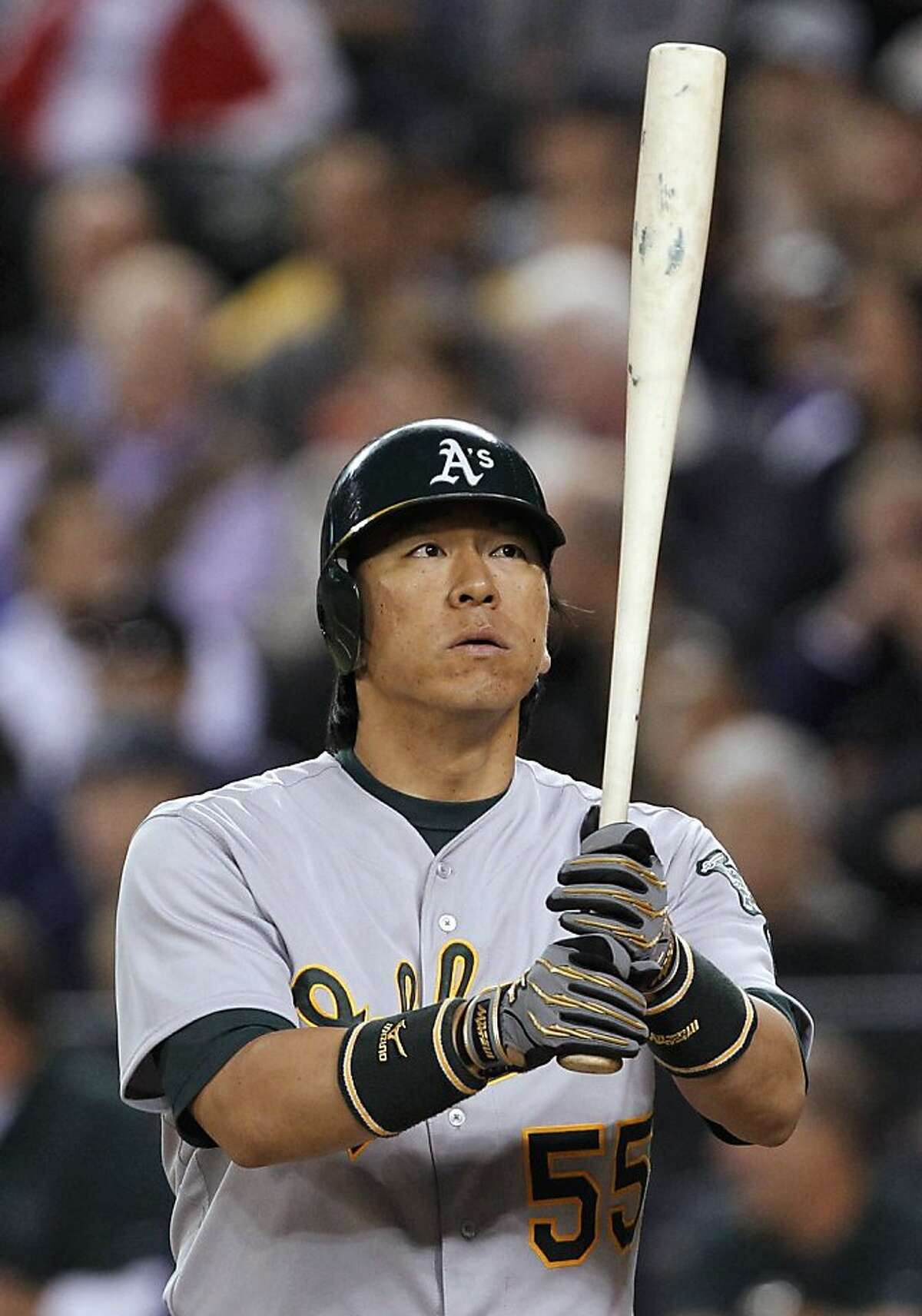Oakland Athletics' Hideki Matsui looks up at his bat during his at-bat against the Seattle Mariners in the first inning of a baseball game Tuesday, Sept. 27, 2011, in Seattle. Matsui singled on the at-bat. (AP Photo/Elaine Thompson)