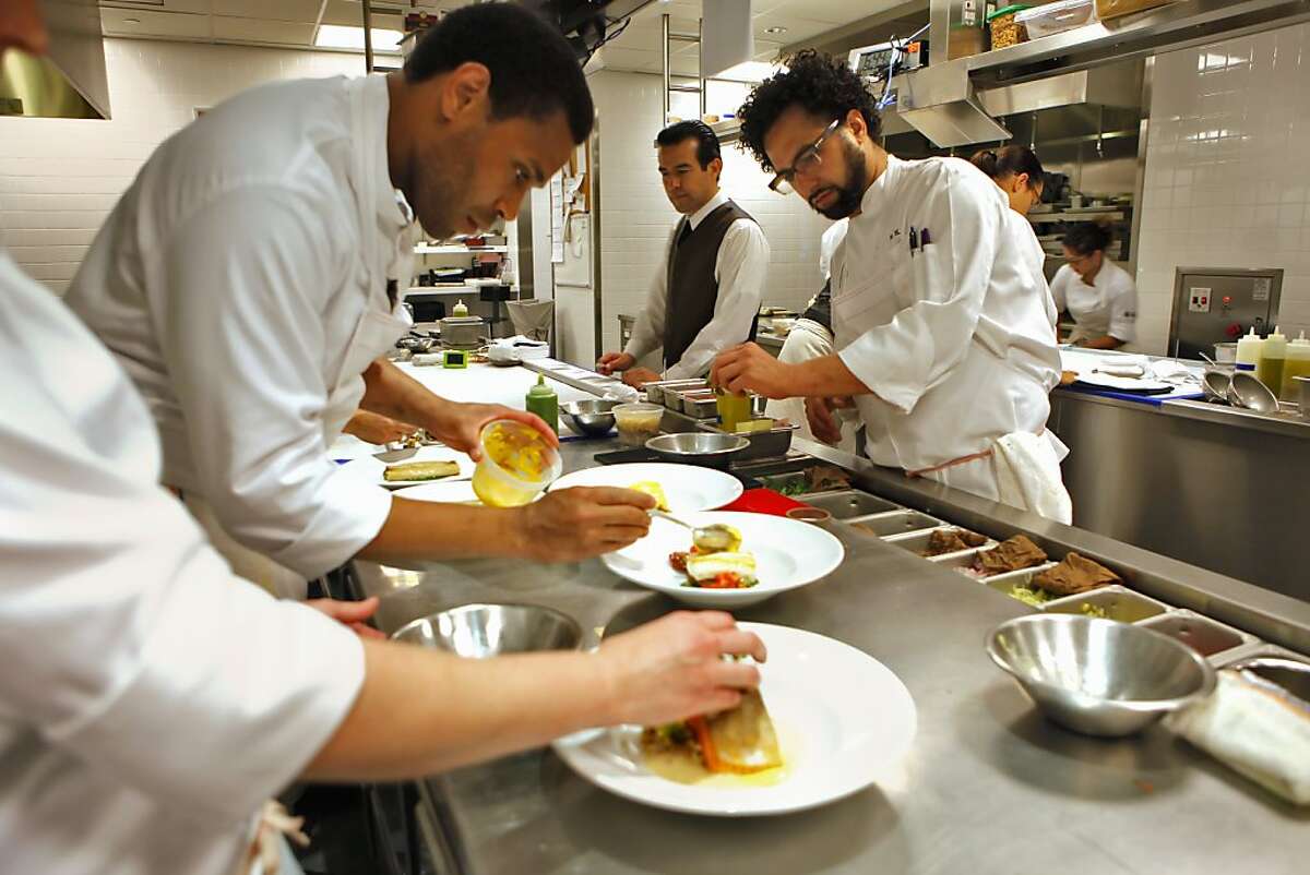 Customers enjoy chef, Ravi Kapur, right, watches as he prepares dinner,Thursday August 26, 2010, at the Prospect restaurant in San Francisco, Calif.
