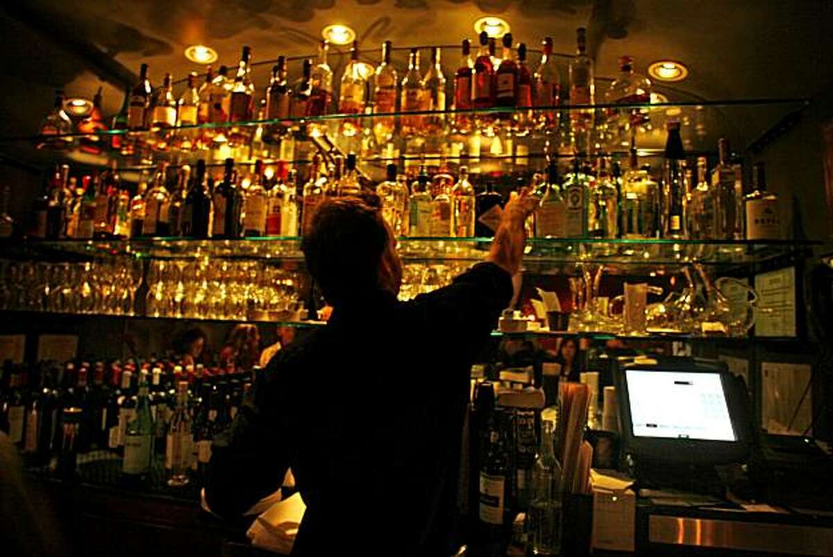 BARBITES28_2705.JPG Bar tender Michael Deming pulls down a bottle of brandy from the extensive array offered at A Cote. College Avenue hotspot in Oakland is A Cote, an intimate restaurant that offers specialty cocktails and French/Mediterranean small plates like Italian Sausage Flatbread, Mussels with Pernod from a wood oven and Pear Gorgonzola Flatbread. Drinks include El Pepino a gin-lime cucumber, cranberry Martini type drink and The Guyana Star made with Plantation Barbados Rum, ginger and limejuice. DECEMBER 09, 2006OAKLAND.By Lance Iversen/San Francisco Chronicle