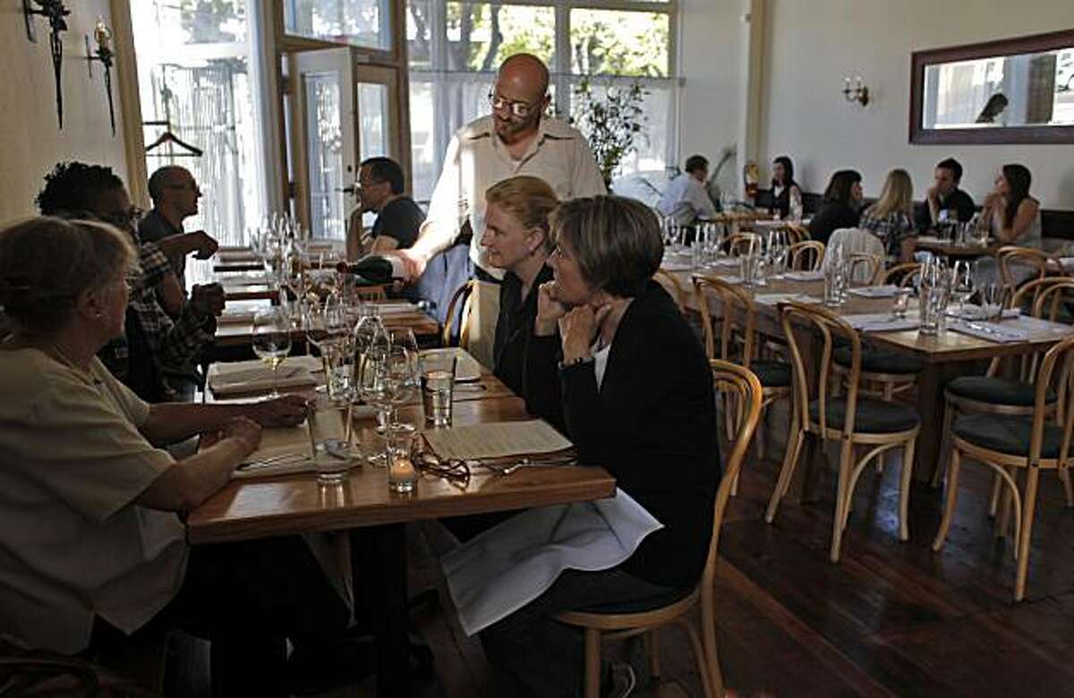 People enjoy dinner with wine at the newly opened Heirloom Restaurant, Tuesday June 29, 2010, in San Francisco, Calif.
