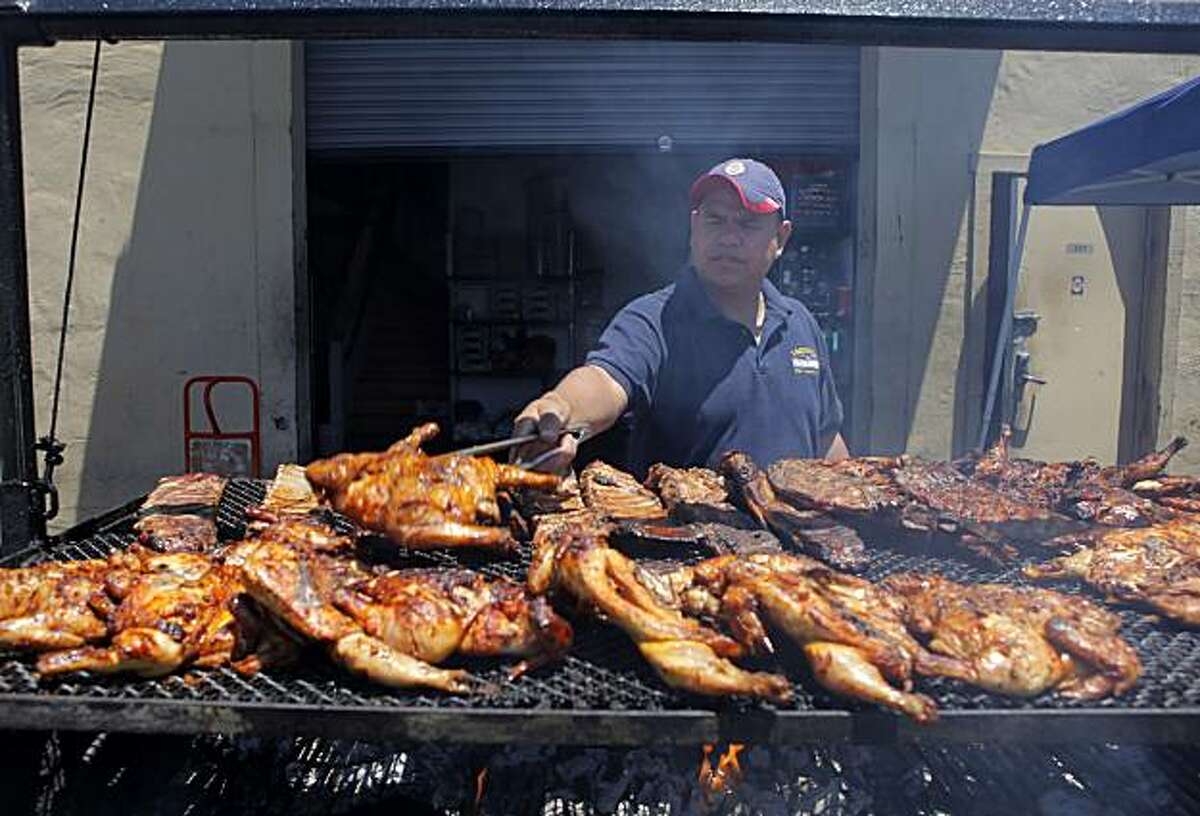 Jose Hernandez works the grill at the Taqueria Guadalajara for lunch, Saturday June 12, 2010, in San Leandro, Calif.