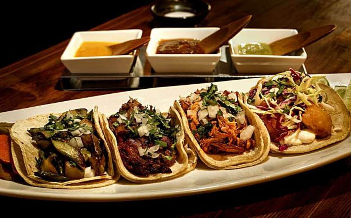 4 Taco Plate, (left to right) 1- asparagus, potato, mushroom and green garlic, 2-Traditional carnitas, 3- beer and shot braised chicken, 4,-fried local rock cod, at the Tacolicious restaurant on Wednesday May, 12, 2010, in San Francisco, Calif. Restaurant review of the Marina District restaurant, Tacolicious.