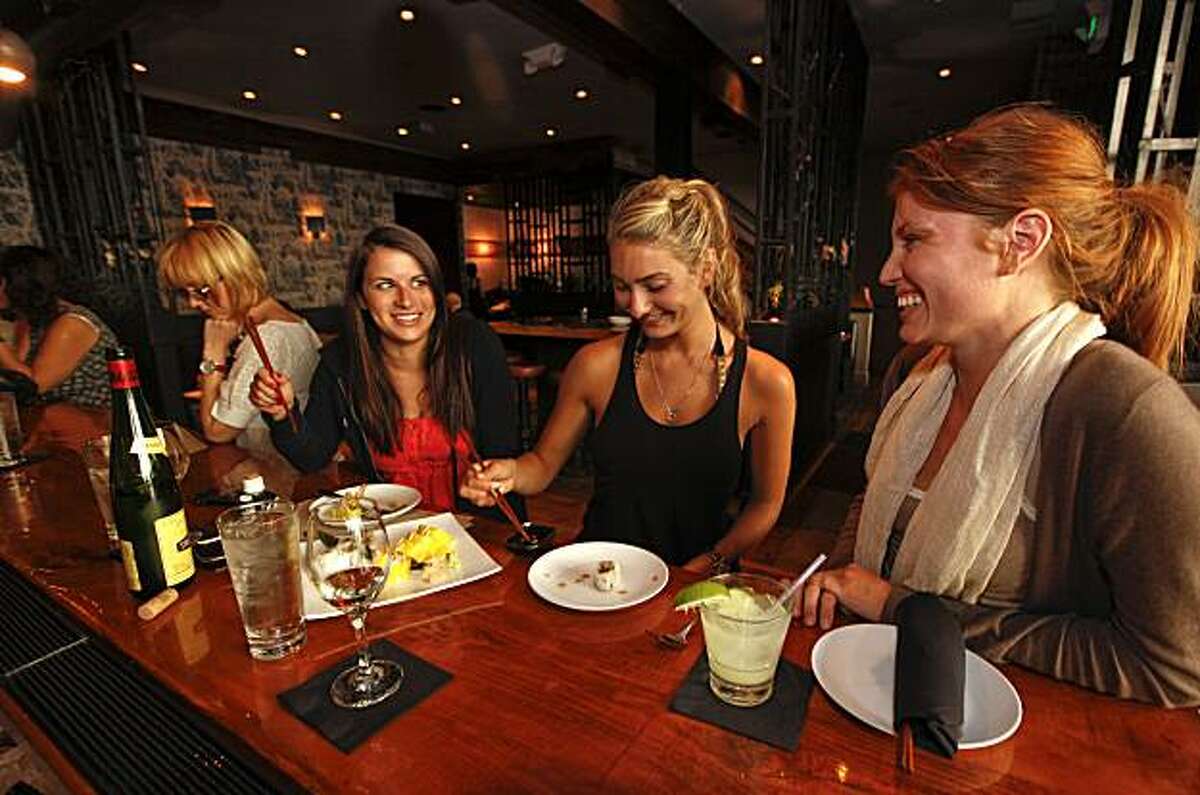 (left to right) Meredith Azis, Alexa Beck and Ryan Eddy, enjoy drinks and appetizers at the bar at "Umami" restaurant in the Cow Hollow/ Marina district of San Francisco, Calif. on Friday May 7, 2010. 96 Hours Bar Bites feature on the bar scene at "Umami" restaurant.