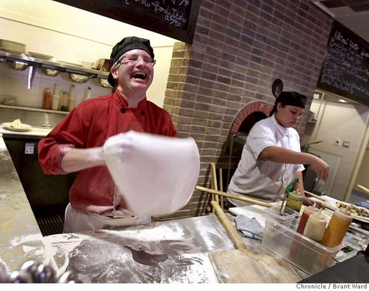 John Franchetti laughs as he prepares pizza dough for his wood burning oven. At right is chef Marilyn Hurley. Rosso Pizzeria and Wine Bar is located at 53 Montgomery Drive in Santa Rosa. (Photo by Brant Ward/San Francisco Chronicle)