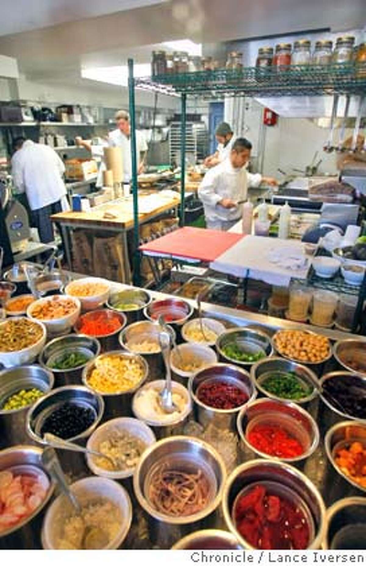 Chefs have a large variety of spices and condiments at their disposal as they prepare meals at the Blue Barn Gourmet Deli at 2105 Chestnut St. near Steiner in San Francisco. By Lance Iversen/The Chronicle