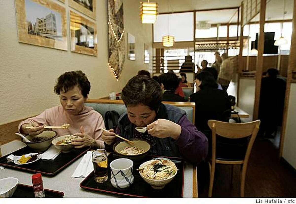 At left is Teruko Nishimoto having hot soba and at right is Emiko Doerner having hot noodles at Hotaru, a Japanese restaurant in San Mateo.