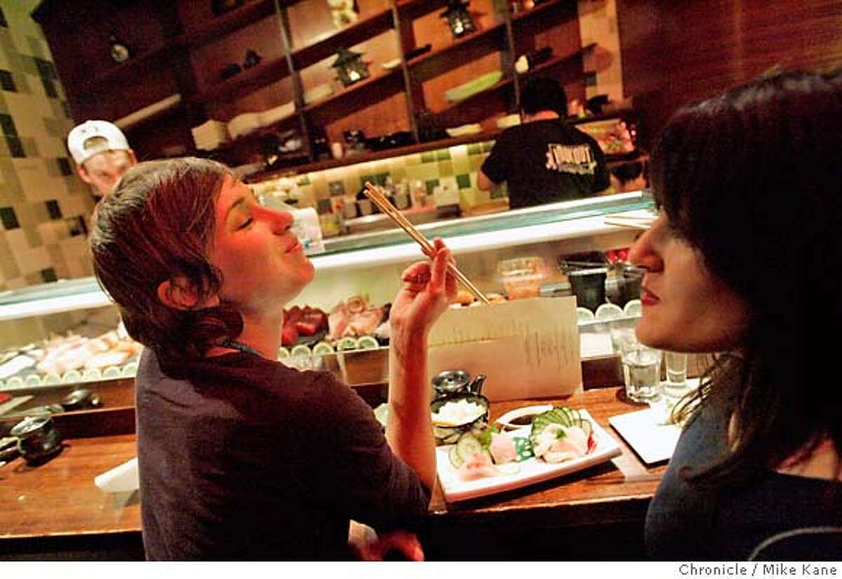 DINE28_tsunami_118_MBK.JPG Natalie Kilmer, left, and friend Jill Weiss eat sushi at the bar at Tsunami Sushi & Sake Bar in the Western Addition/NOPA district in San Francisco, CA, on Wednesday, February, 21, 2007. photo taken: 2/21/07 Mike Kane / The Chronicle **Natalie Kilmer, Jill Weiss MANDATORY CREDIT FOR PHOTOG AND SF CHRONICLE/NO SALES-MAGS OUT