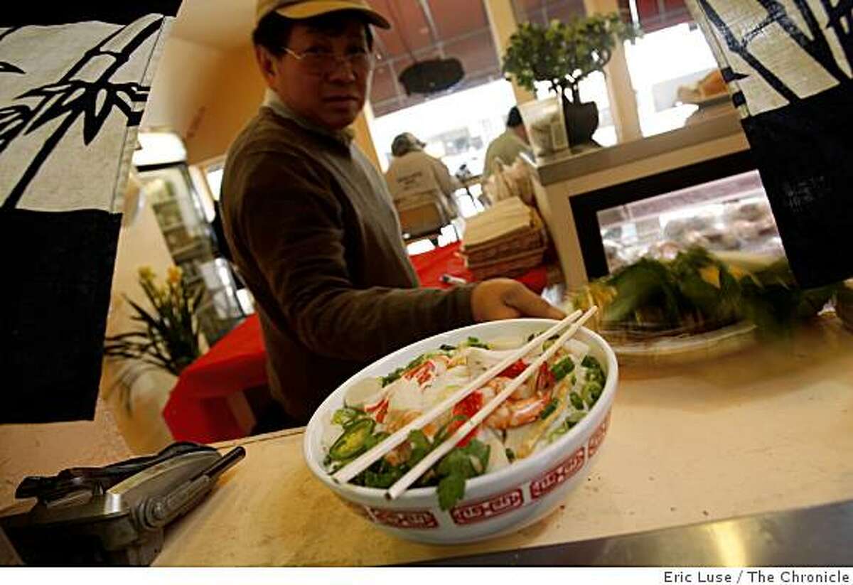 David Huynh, owner Linda Lam's father, picks up an order of Seafood Noodle Soup dish at the Little Vietnam Cafe in San Francisco photographed on Friday, February 27, 2009.