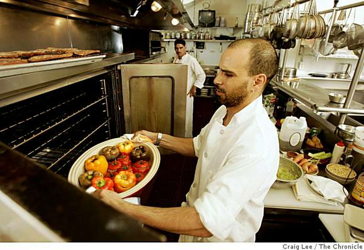 MOROCCAN14_307_cl.JPG Photo of Mourad Lalou putting a dish of Stuffed Bell Peppers with Ground beef and Lamb, with Tomato Sauce, in the convection oven to finish it off. Cooking with Moroccan chef, Mourad Lalou at his restaurant, Aziza at 5800 Geary Blvd. at 22nd. Story on Moroccan trinity of ingredients: tomatoes, eggplant and peppers.Event on 8/9/05 in San Francisco.Craig Lee / The Chronicle