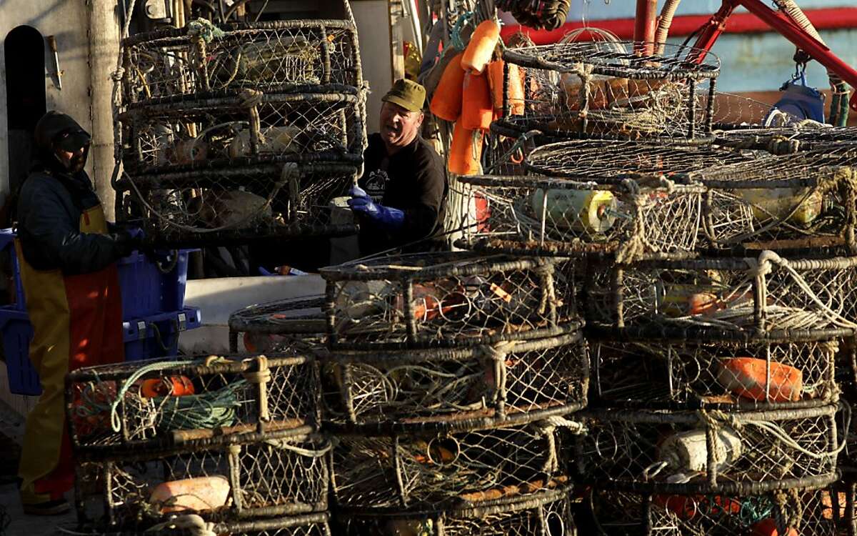 Fisherman Bobby Jackson and Danny Murray stack crab pots on their boats as they prepare to go out to sea, Monday Nov. 28, 2011, at Pier 45 in San Francisco, Calif. After arguing about the price and delaying crab season an agreement has been made on paying the fisherman $2.25 a pound.