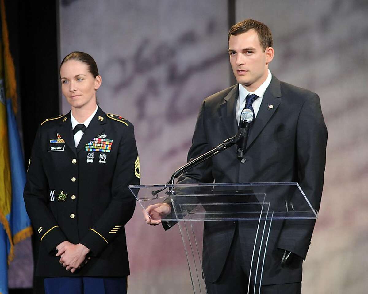 PHILADELPHIA, PA - SEPTEMBER 22: Sergeant First Class Dana Graham (L) and Captain (Retired) Anthony Odierno (R) stand on stage before presenting Former U.S. Secretary of Defense Dr. Robert M. Gates is with the 2011 Liberty Medal September 22, 2011 in Philadelphia, Pennsylvania. Gates as a widely respected leader who has built a legacy of defending freedom, promoting effective diplomacy and supporting American troops around the world. (Photo by William Thomas Cain/Getty Images)
