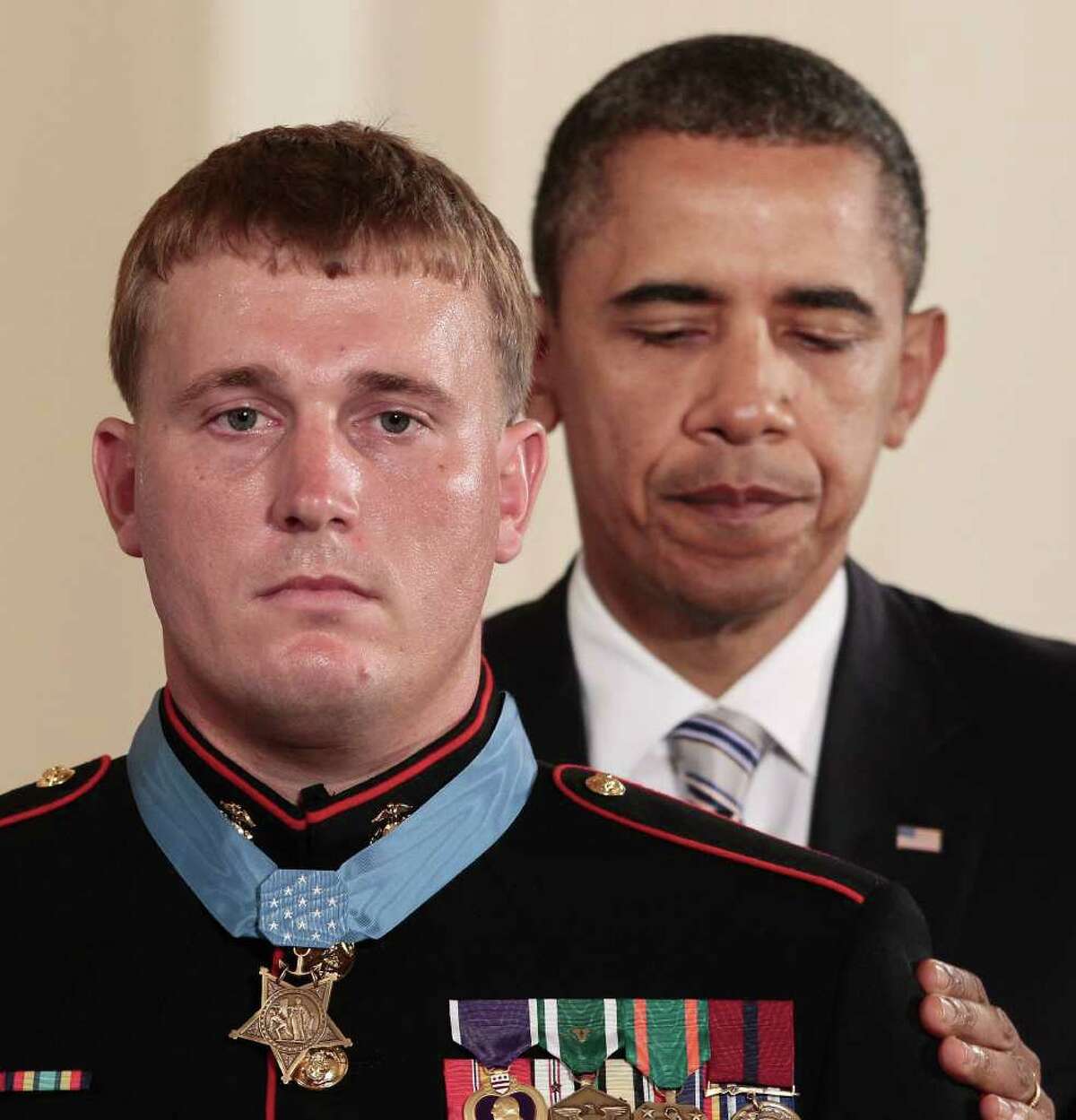 FILE - In this Sept. 15, 2011 file photo, President Barack Obama awards the Medal of Honor to former Marine Corps Cpl. Dakota Meyer, 23, from Greensburg, Ky., during a ceremony in the East Room of the White House in Washington. Meyer is suing defense contractor BAE Systems OASYS Inc., claiming that a manager at the company ridiculed his Medal of Honor, called him mentally unstable and suggested he had a drinking problem, thereby costing him a job.