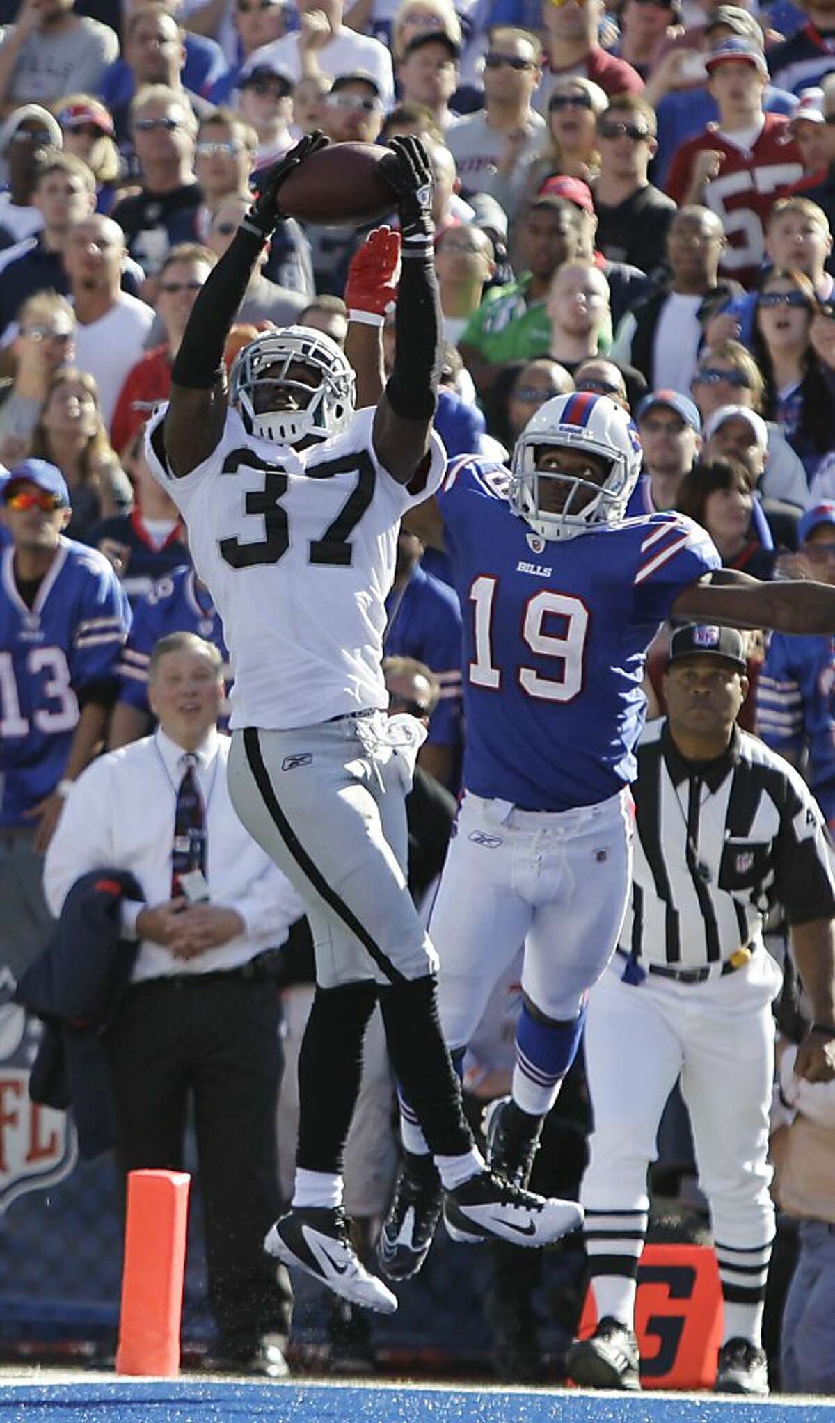 Oakland Raiders' Chris Johnson (37) breaks up a pass intended for Buffalo Bills' Donald Jones (19) during the second half of an NFL football game in Orchard Park, N.Y., Sunday, Sept. 18, 2011. The Bills won 38-35. (AP Photo/David Duprey)