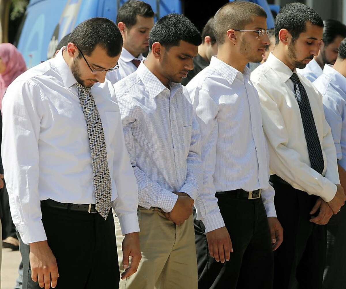 Four students, from left: Taher Herzallah, Mohammad Qureashi, Aslam Traina, and Mohamad Abdelgany pray outside court after being convicted of disrupting a speech by Israeli Ambassador Michael Oren, at the University of California, Irvine, last year, at the Central Justice Center court, Friday, Sept. 23, 2011 in Santa Ana, Calif. A California jury on Friday convicted 10 Muslim students of illegally disrupting Oren's speech in a case that has stoked an intense debate about free speech. (AP Photo/Damian Dovarganes)