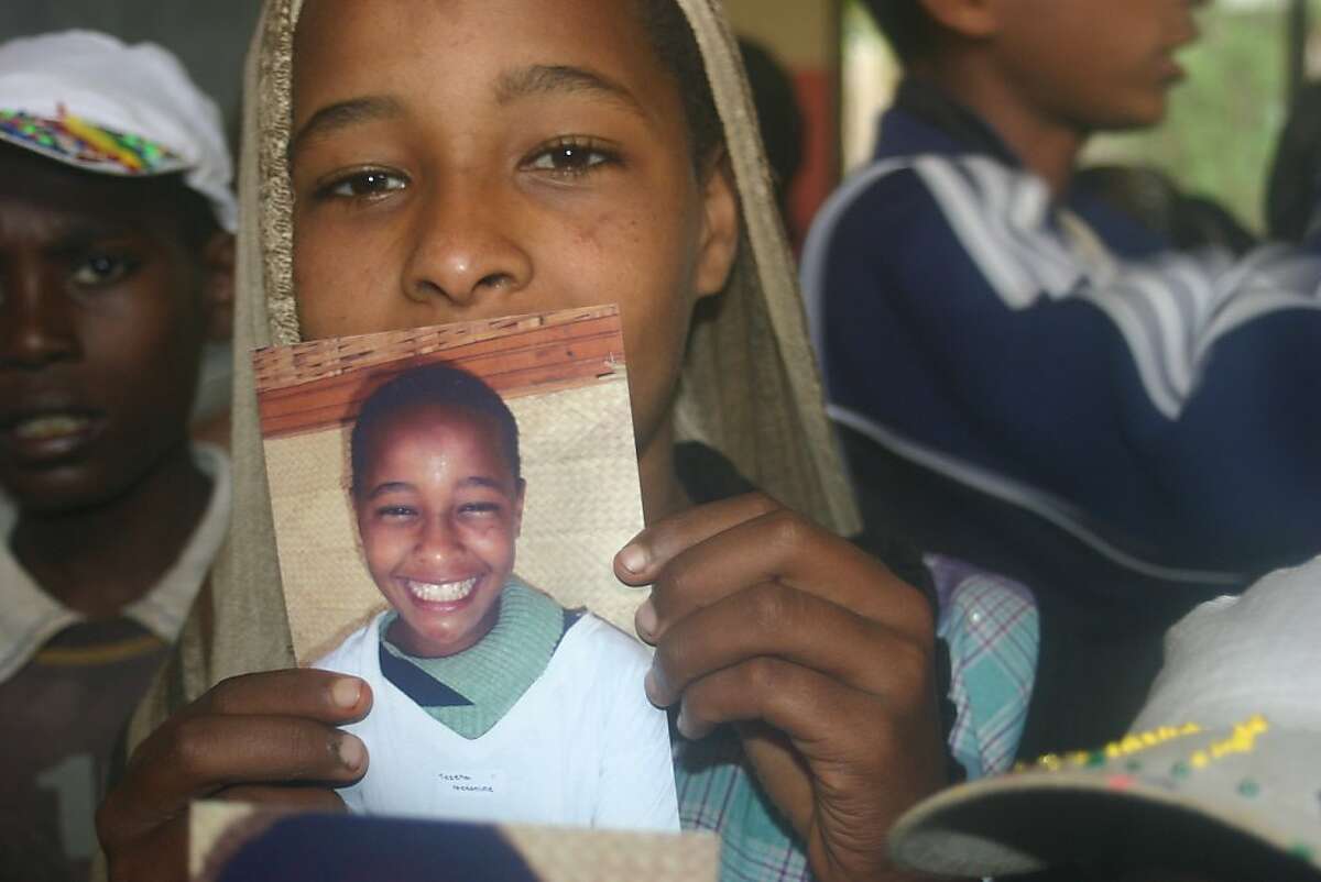 An Ethiopian girl with her class photo taken by Sammy novick of Mill Valley.