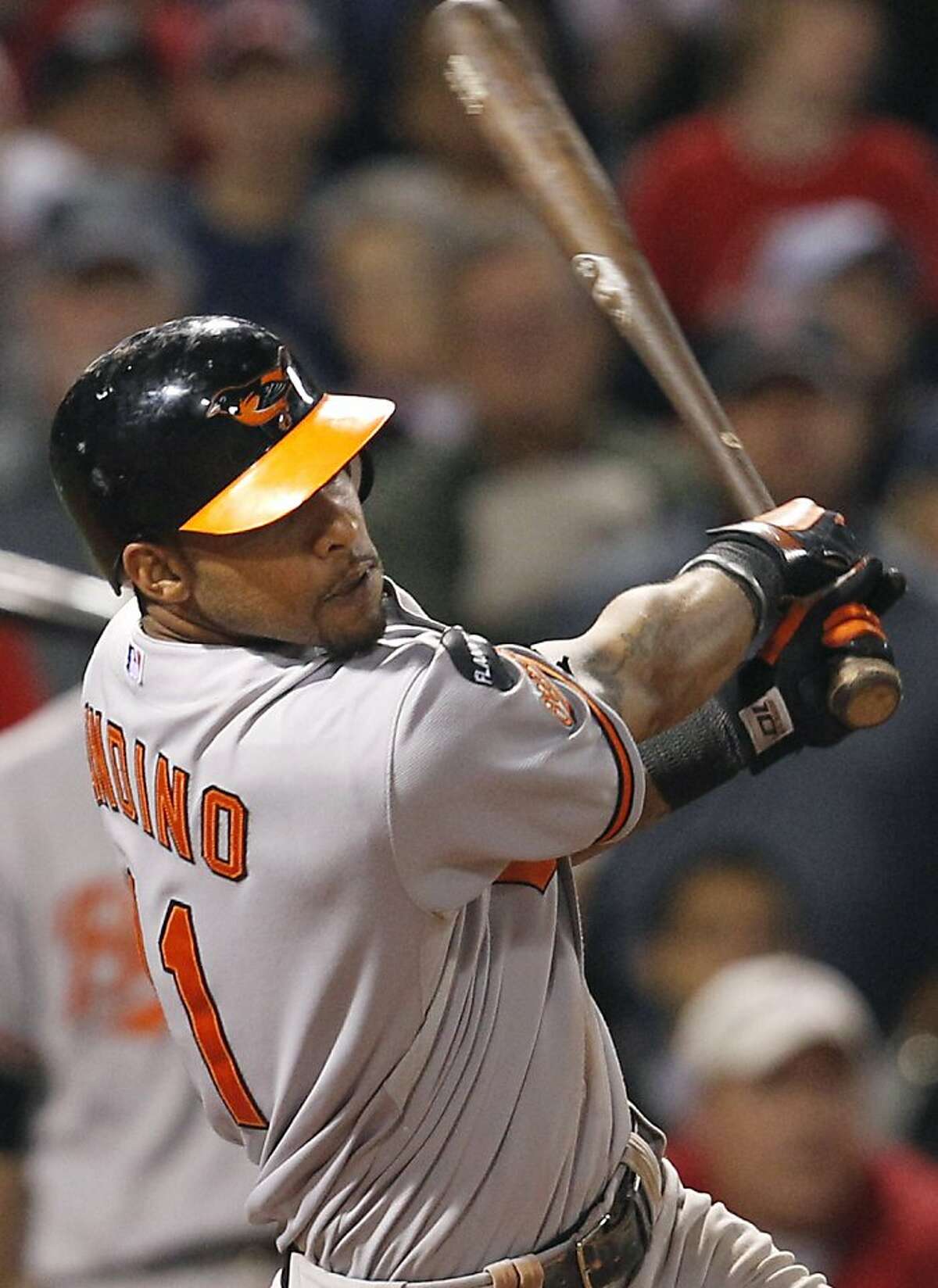 Baltimore Orioles' Robert Andino watches his three-run double against the Boston Red Sox in the eighth inning of a baseball game at Fenway Park in Boston, Tuesday, Sept. 20, 2011. (AP Photo/Elise Amendola)