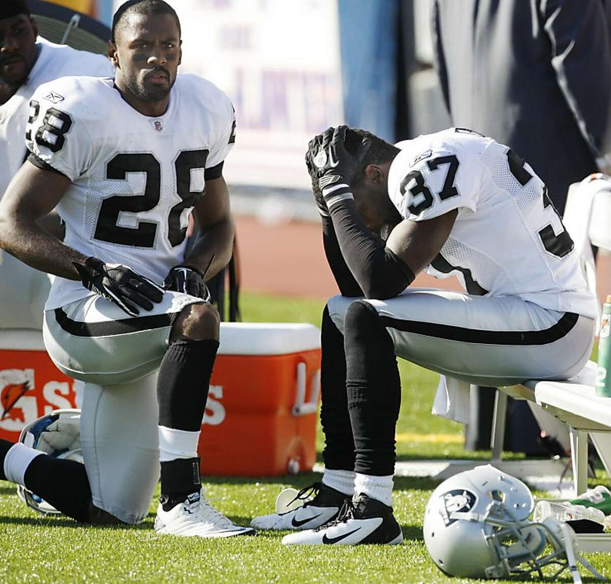 Oakland Raiders' Chris Johnson (37) and Joe Porter (28) react after the Buffalo Bills scored late in the fourth quarter of an NFL football game in Orchard Park, N.Y., Sunday, Sept. 18, 2011. The Bills won 38-35. (AP Photo/David Duprey)