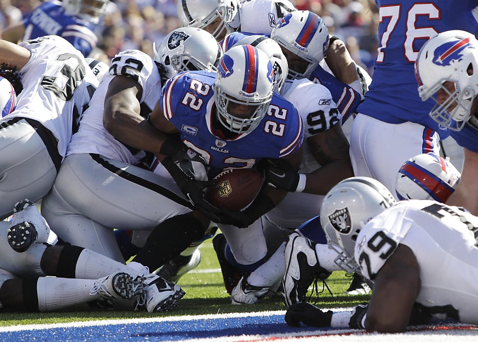 Buffalo Bills' Stevie Johnson (13) makes a catch under pressure from  Oakland Raiders' Matt Giordano (27) during the second half of an NFL  football game in Orchard Park, N.Y., Sunday, Sept. 18