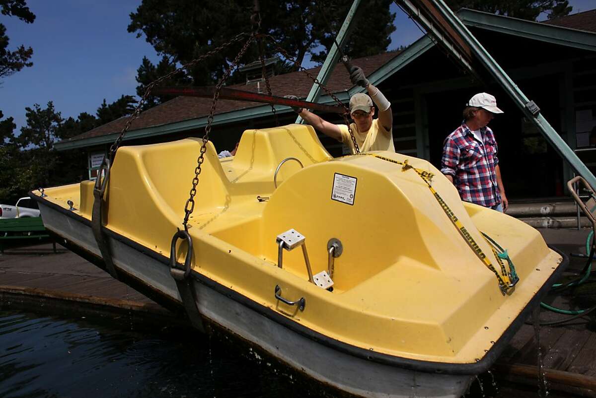 Jon Luckenoff, asst. manager, and Jeff Fones, manager of the Stowe Lake Boat House in Golden Gate park, haul a paddle boat out of the lake on Monday Sep. 12, 2011 in San Francisco, Calif. The snack bar/boat rental venue has eight days to move their stuff out of the building after 68 years of business.