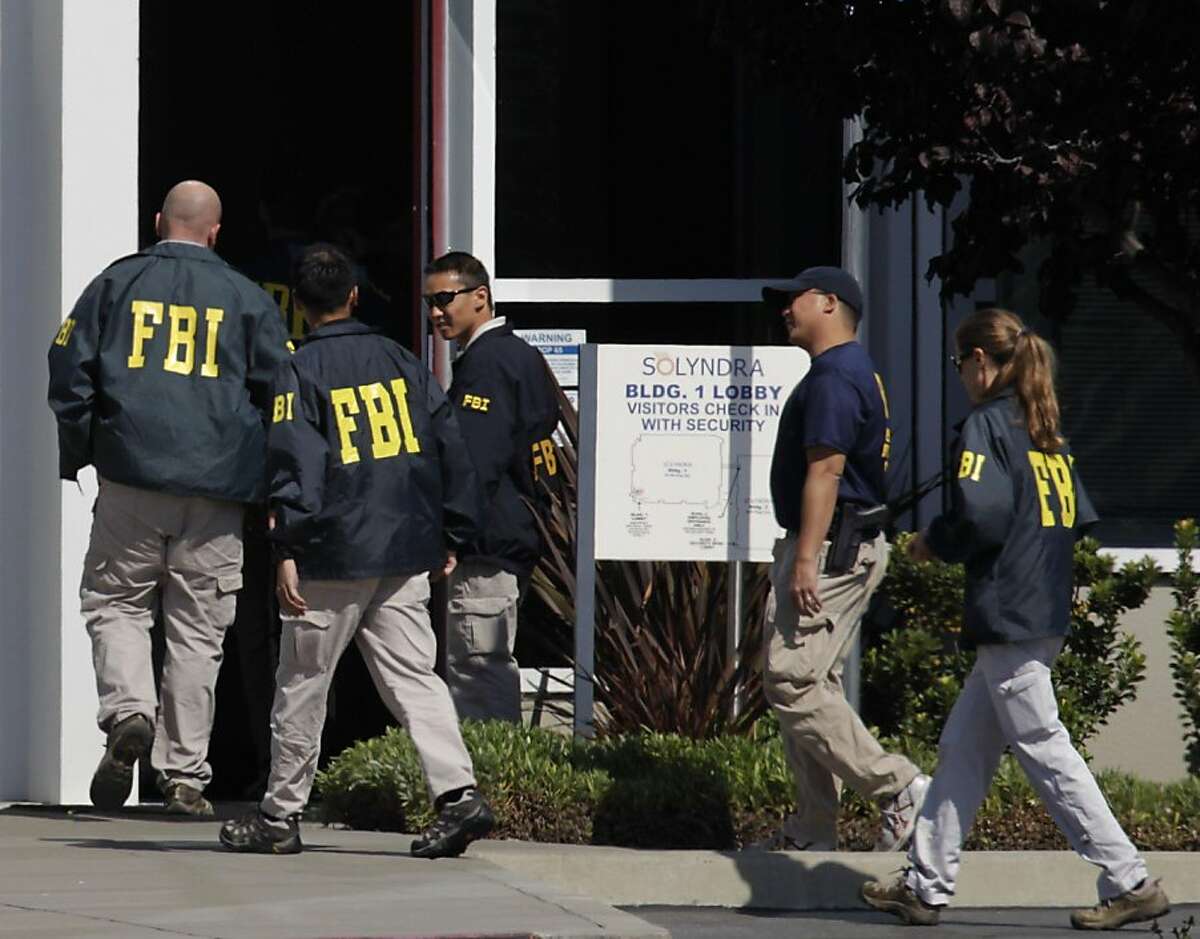 FBI agents enter the lobby of the Solyndra solar company offices after serving search warrants in Fremont, Calif. on Thursday, Sept. 8, 2011. Last week, Solyndra laid off all of its 1,100 employees after filing for bankruptcy. Ran on: 09-09-2011 FBI agents enter the Solyndra solar company offices in Fremont after serving search warrants. Last week, Solyndra laid off 1,100 employees and later declared bankruptcy.