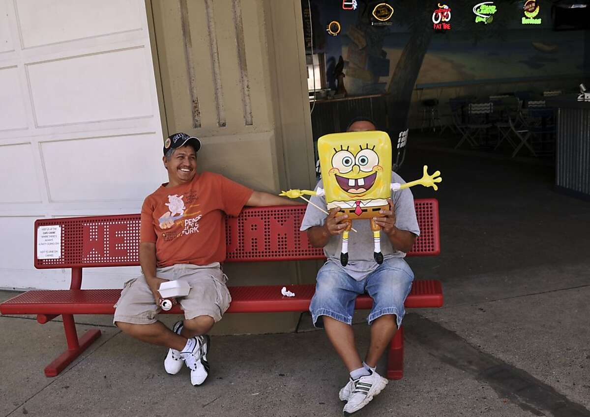 Albert Martinez laughs at his friend Roy Trejo who holds a Sponge Bob balloon in front of his face in Falcon Heights, Minn. The two run a small Souvenir shop and were getting ready for the Minnesota State Fair, on Wednesday, Aug. 24, 2011. (AP Photo/Star Tribune, Richard Sennott)