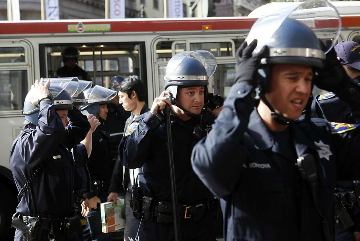 San Francisco Police officers don helmets before closing down the Powell Street BART and MUNI station following a protest involving free speech in the ticket area of the station on Thursday, September 8, 2011 in San Francisco, Calif.
