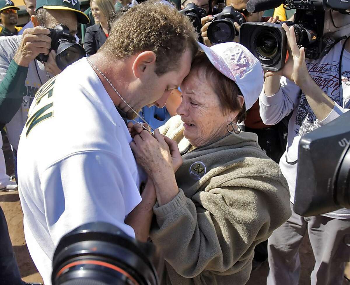 Dallas Braden celebrates with his grandmother, Peggy Lindsey of Stockton, Calif., after pitching a perfect game on Mother's Day. Braden's mother has passed away and his grandmother attended the game. The chain around Braden's neck is a memoir of his mother that used to hold her wedding ring until he lost it years ago. He has worn it for years and when it has broken, he's held it together with paper clips and safety pins according to Lindsey. The perfect game is the 19th in MLB history. The Oakland Athletics played the Tampa Bay Rays at the Oakland Alameda County Coliseum in Oakland, Calif., on Sunday, May 9, 2010. Ran on: 05-10-2010 After his incredible feat Sunday, Dallas Braden embraces his grandmother, Peggy Lindsey, at the Oakland Coliseum. He could not hug his mother, who died of cancer when he was in high school. Ran on: 05-10-2010 After his incredible feat Sunday, Dallas Braden embraces his grandmother, Peggy Lindsey, at the Oakland Coliseum. She raised him after his mother died of cancer while he was in high school. **MANDATORY CREDIT FOR PHOTOG AND SF CHRONICLE/NO SALES/MAGS OUT/TV OUT/INTERNET: AP MEMBER NEWSPAPERS ONLY**