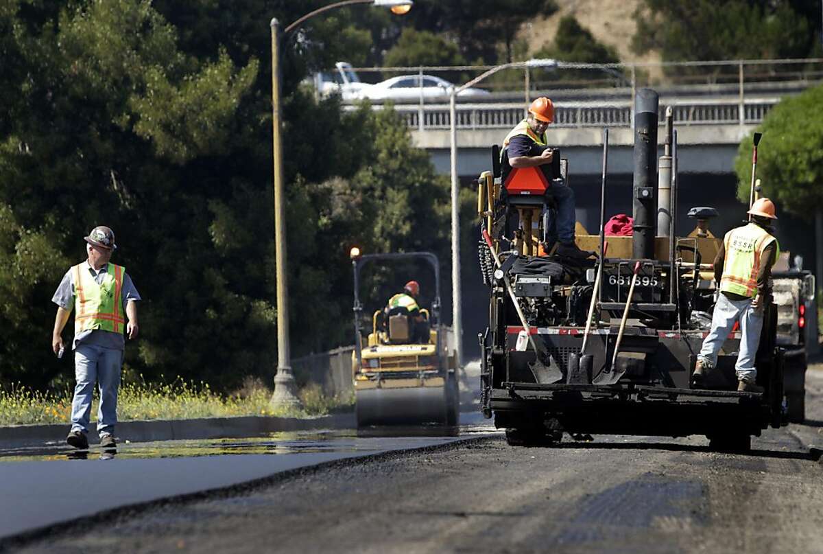 A Department of Public Works road crew repaves an access road leading to southbound Highway 101 and Bayshore Boulevard from Third and Jamestown streets in San Francisco, Calif. on Friday, Sept. 9, 2011. If passed by voters, a bond measure would pour an additional $248 million into repairing city streets, sidewalks and curbs.