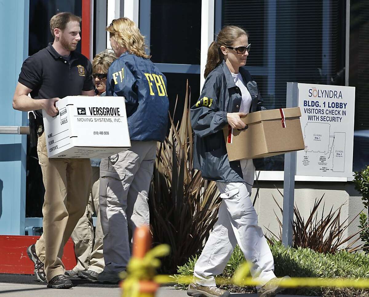 FBI agent carry dozens of boxes of evidence from Solyndra headquarters in Fremont, Calif., Thursday, Sept. 8, 2011. The FBI are executing search warrants at the headquarters of California solar firm Solyndra that received a $535 million loan from the federal government. (AP Photo/Paul Sakuma)