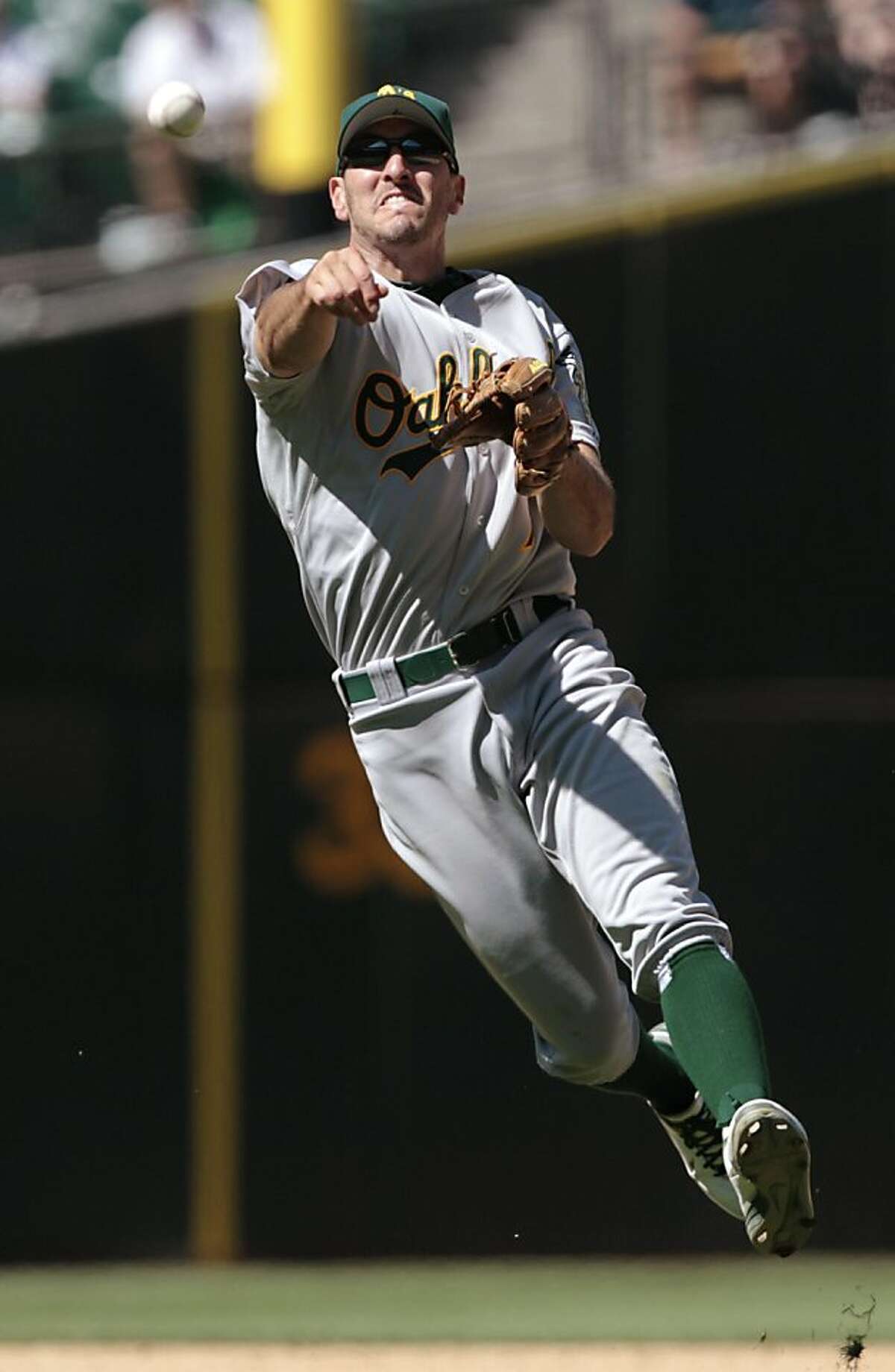Oakland Athletics shortstop Adam Rosales throws to first on a grounder from Seattle Mariners' Greg Halman in the eighth inning of a baseball game Wednesday, Aug. 3, 2011, in Seattle. (AP Photo/Elaine Thompson)