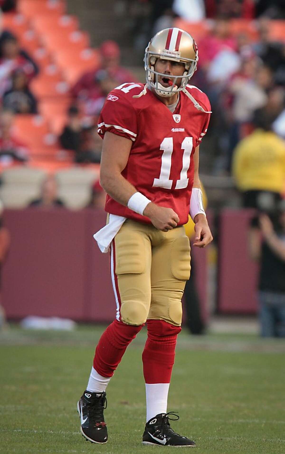 A frustrated 49er quarterback Alex Smith walks off the field after throwing an interception during the 49er-Texans game at Candlestick Park in San Francisco, Calif., on Friday, August 12th, 2011.