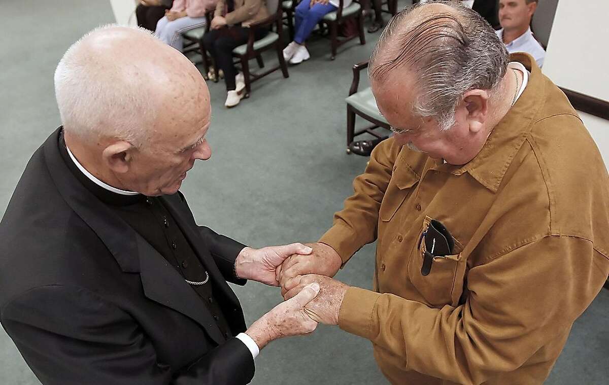 Bishop Emeritus Edmund Carmody blesses the hands of Chaplin Rick Costley during the ÒBlessing of the HandsÓ ceremony at Trinity Towers in Corpus Christi, Texas, Thursday, Nov. 10, 2011 during a ceremony to honor Hospice Awareness Month.(AP Photo/Corpus Christi Caller-Times,Todd Yates) MANDATORY CREDIT