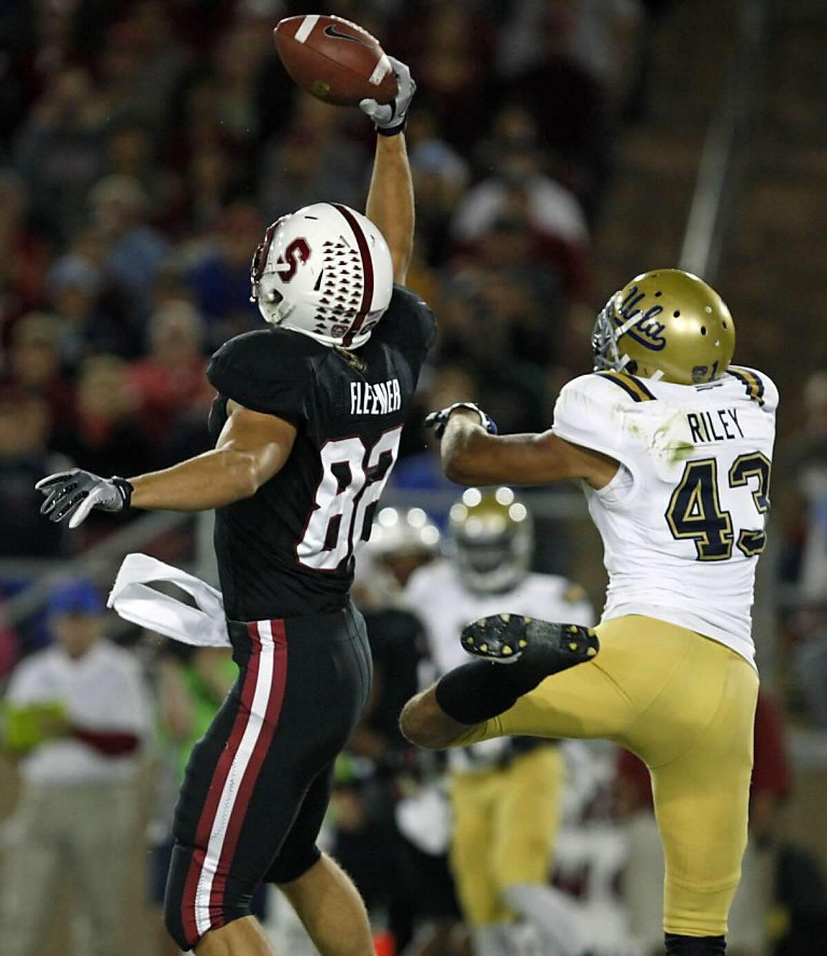 Stanford's tight end Coby Fleener (82) makes a one handed touchdown catch from quarterback Andrew Luck #12 against the UCLA BruinÍs at Stanford Stadium on October 1, 2011 in Stanford California. The Cardinal lead the BruinÍs 17-7 at the half.