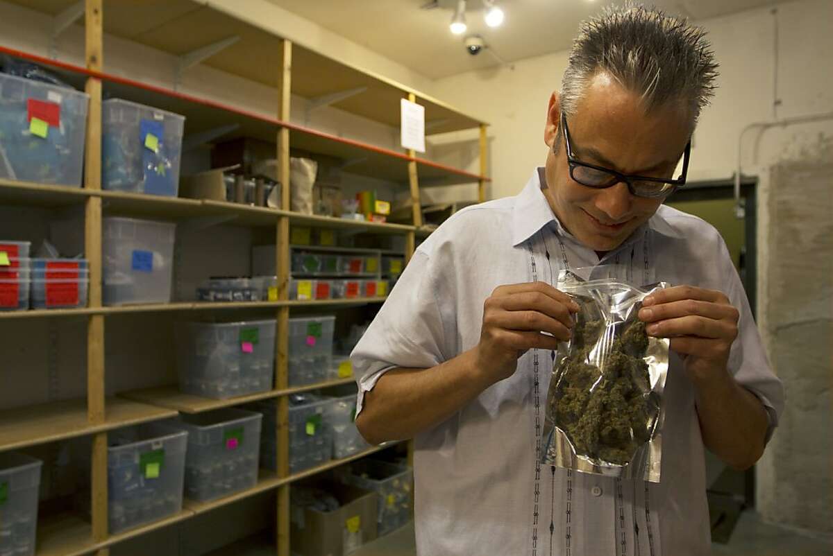 Andrew DeAngelo examines an ounce of high-grade medical cannabis on, "Weed Wars," airing on the Discovery Channel.