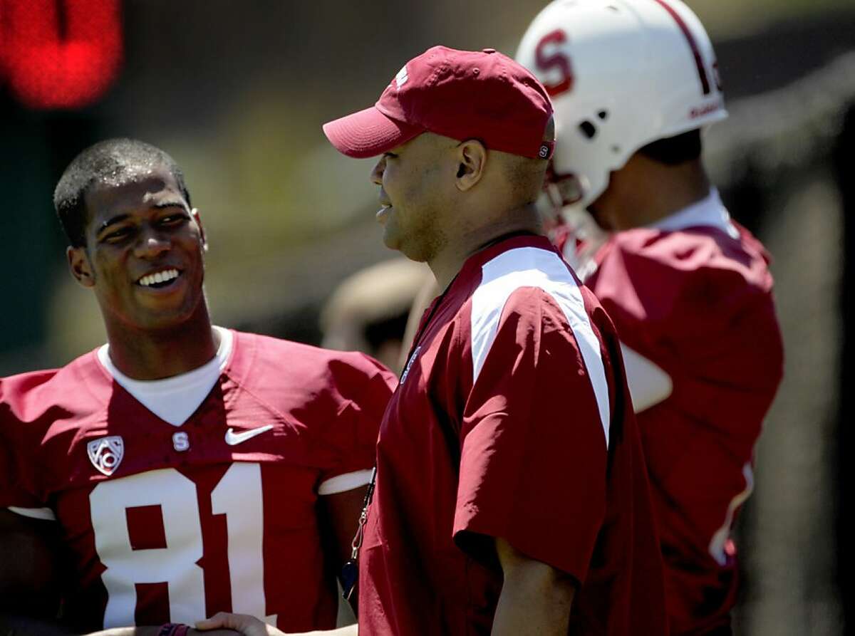 The Stanford's head coach David Shaw, center talks with wide receiver Chris Owusu during the first practice, Monday August 8, 2011, in Stanford Calif. Ran on: 08-09-2011 Head coach David Shaw (right) has a chat with wide receiver Chris Owusu during Mondays practice. Ran on: 08-09-2011 Head coach David Shaw (right) has a chat with wide receiver Chris Owusu during Mondays practice.
