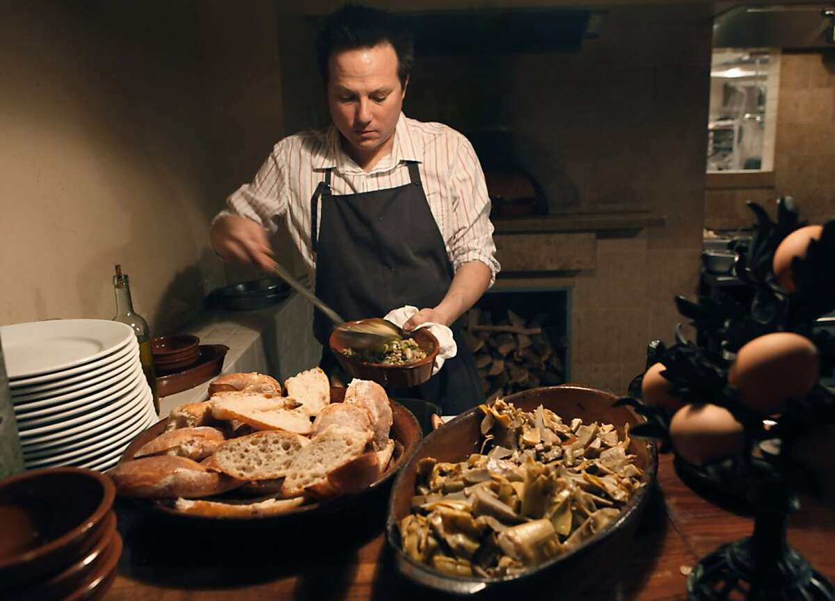 Chef/owner Russell Moore prepares dishes that will be cooked in the wood-fired oved at Camino restaurant in Oakland, Calif., on Wednesday, October 7, 2009. Chef/owner Russell Moore is doing the cooking.
