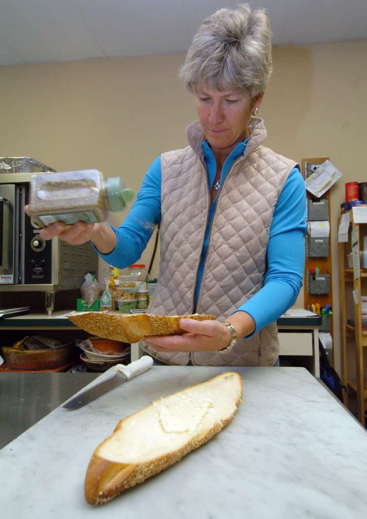Sue Eskierski, of Villarina Pasta store in New Milford and Southbury, works at the store making garlic bread Wednesday, Oct. 21, 2009.