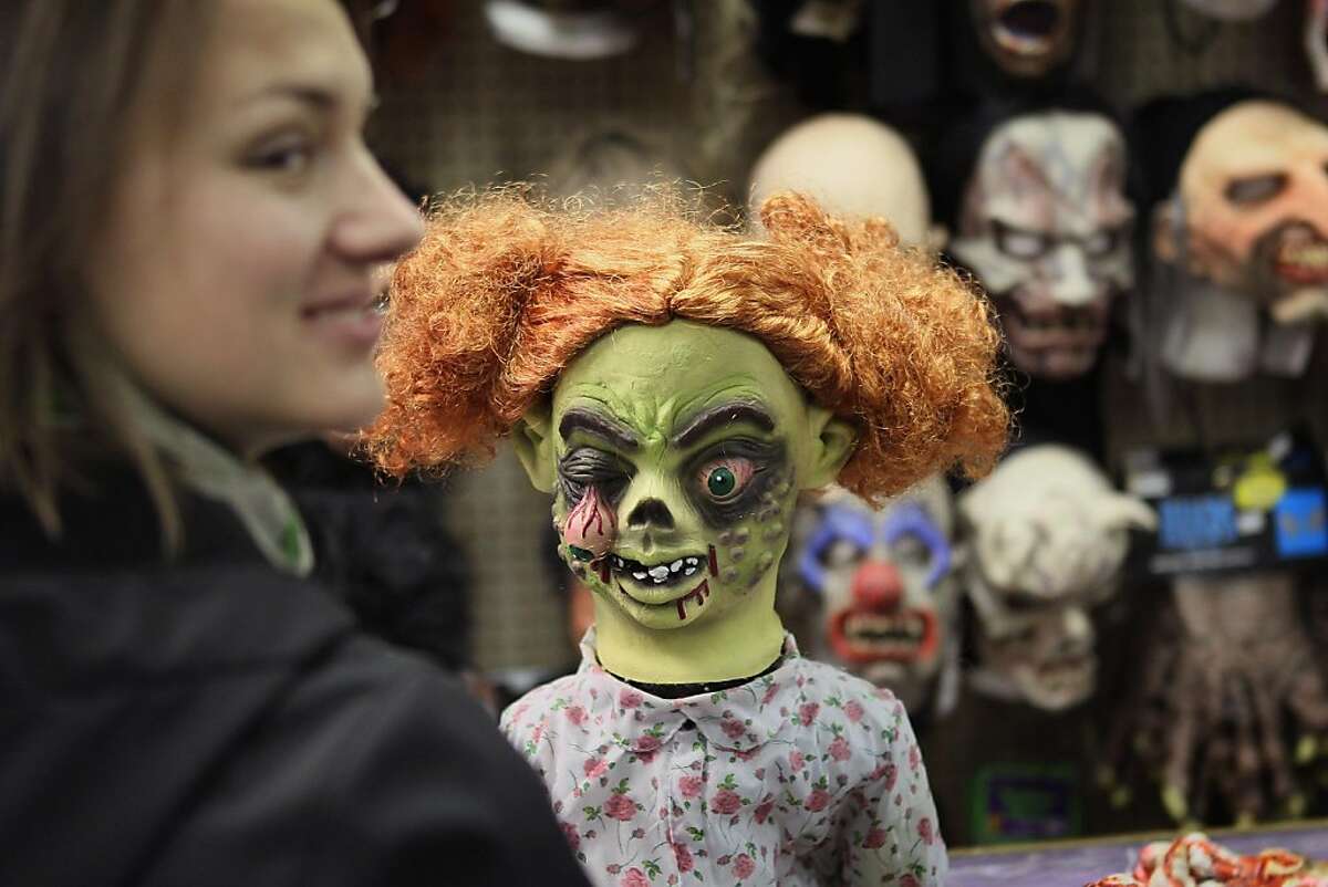 CHICAGO, IL - OCTOBER 28: A customer shops for a Halloween mask at Fantasy Costumes on October 28, 2011 in Chicago, Illinois. The store, which had long lines at the registers at 4 AM this morning, is open around the clock through Halloween to help keep up with customer demand. Retailers nationwide are expecting record sales for Halloween merchandise this year with shoppers spending close to $7 billion dollars to celebrate the holiday. (Photo by Scott Olson/Getty Images)