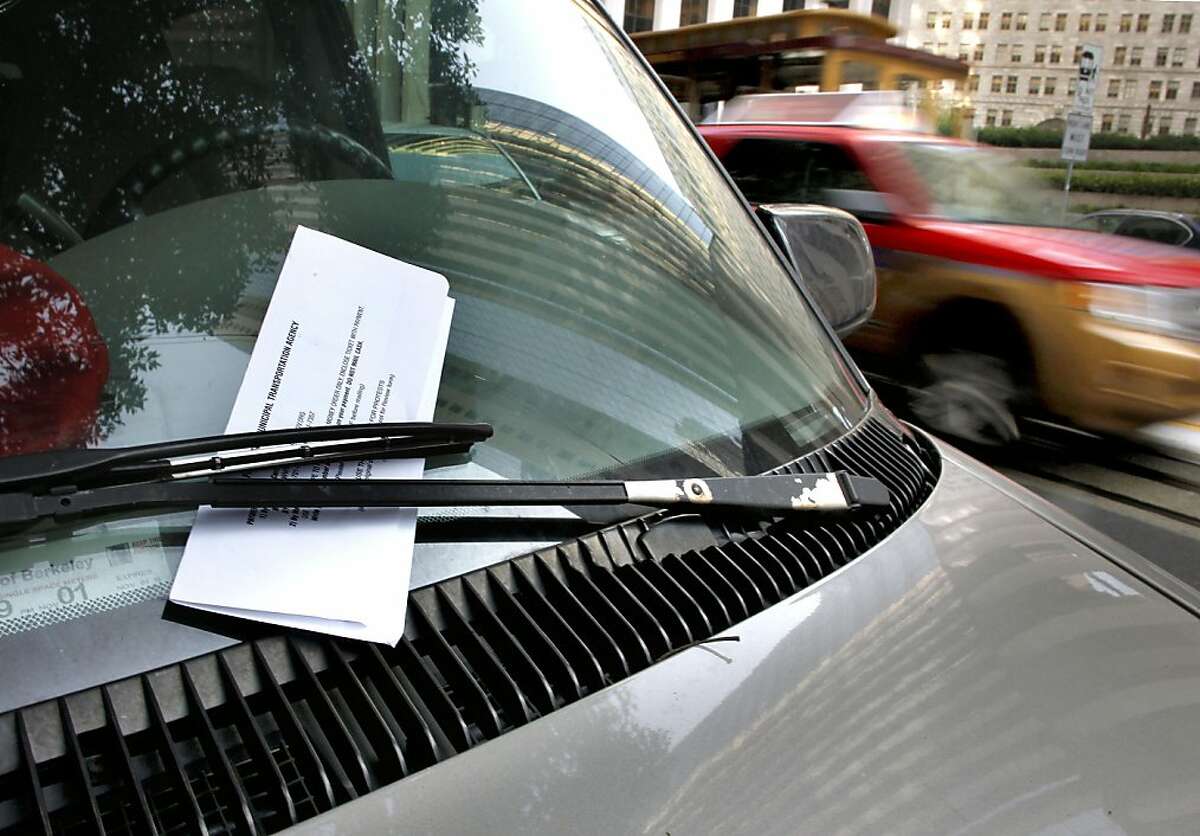 A parking citation on the windshield of a vehicle in the financial district on Thursday November 10, 2011 in San Francisco, Ca. The Municipal Transportation Agency is facing a $34 million deficit for next year and a $46 million deificit for the next year. Ideas to help erase that gap include charging riders who pay cash fares an extra 25 cents, and another 25 cents on top of that if they use a transfer. Also being considered is making drivers pay $3 more for parking fines and having parking meters fed on Sundays and later into the evenings and the idea to tack another $3 onto parking penalties was broached briefly over the summer and then shelved in the months leading up to the Tuesday mayoral election.