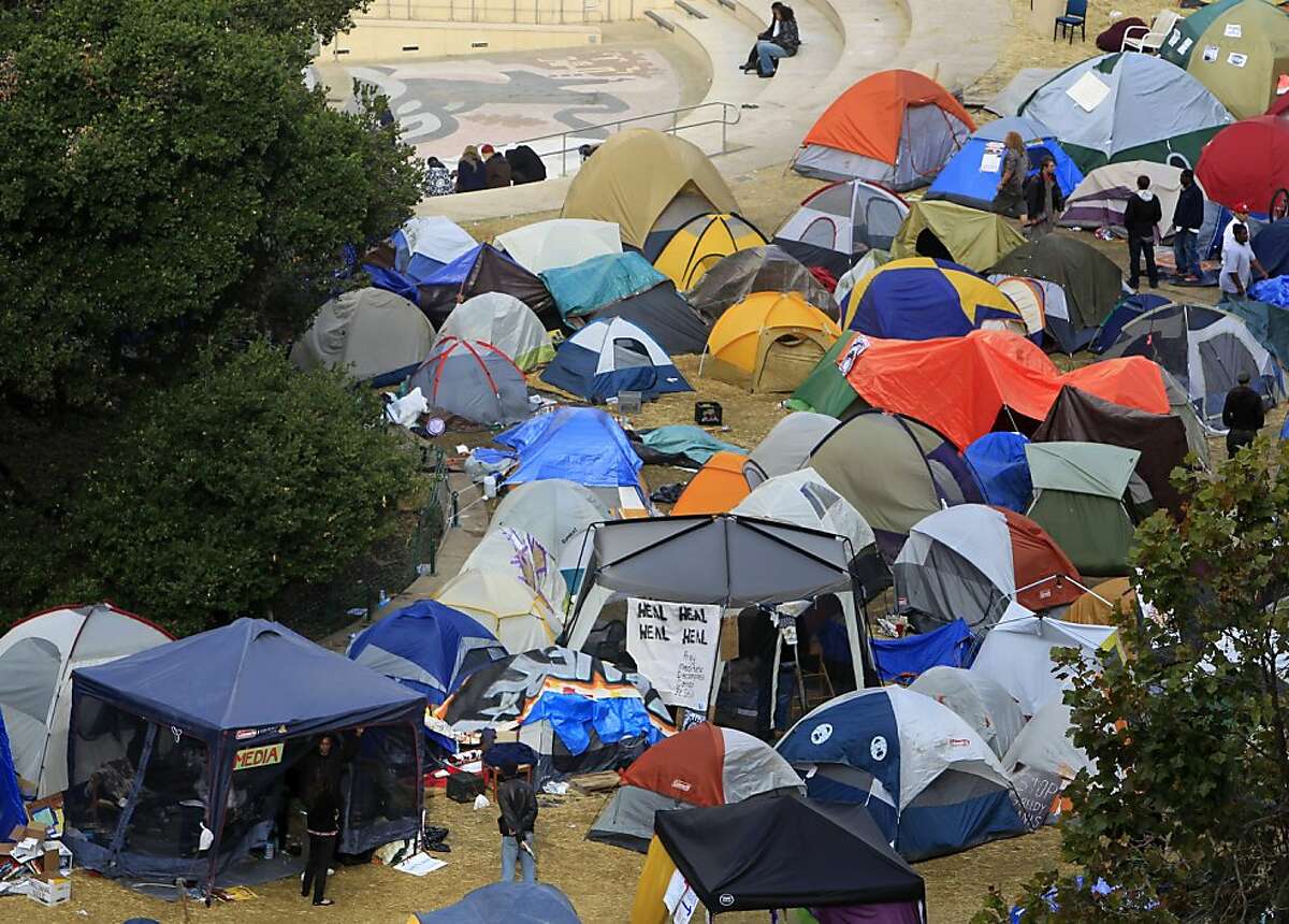 Campers in the Occupy Oakland encampment emerge from their tents after a night of violence in Oakland, Calif. on Thursday, Nov. 3, 2011.