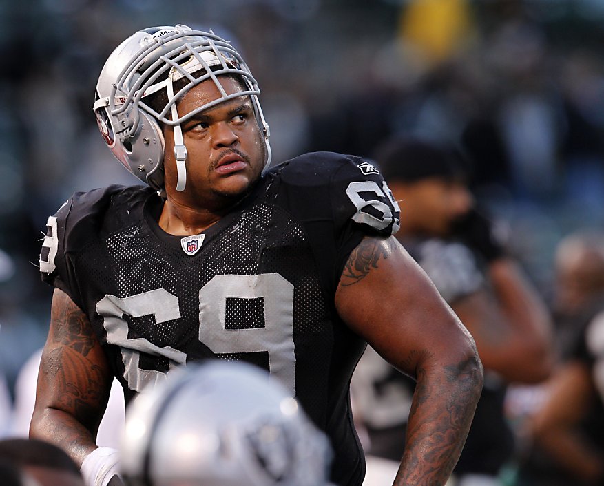 A logo for recently passed Oakland Raiders owner Al Davis is shown on the  helmet of defensive end Jarvis Moss (94) in the fourth quarter of an NFL  football game against the