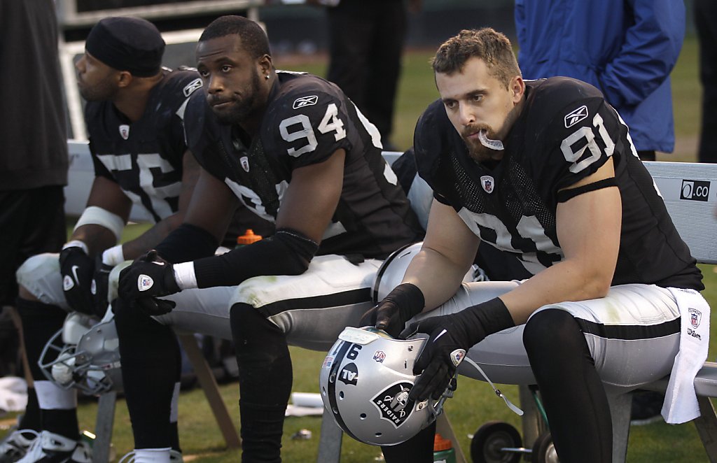 A logo for recently passed Oakland Raiders owner Al Davis is shown on the  helmet of defensive end Jarvis Moss (94) in the fourth quarter of an NFL  football game against the