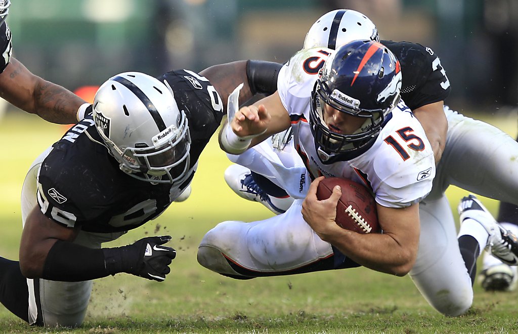 A logo for recently passed Oakland Raiders owner Al Davis is shown on the  helmet of defensive end Jarvis Moss (94) in the fourth quarter of an NFL  football game against the