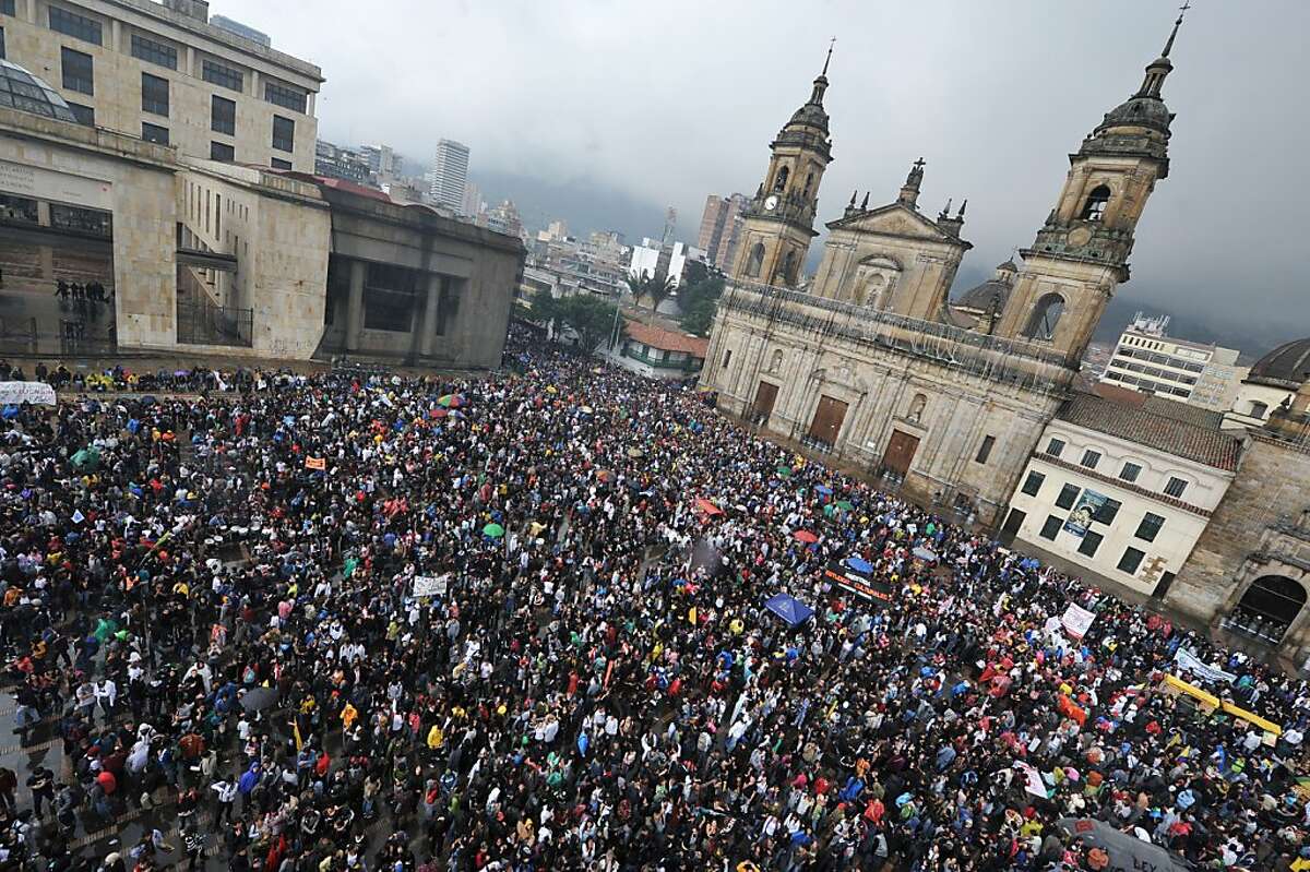 Students take part in a demonstration against an education reform bill at Bogota's main square Plaza de Bolivar, on November 10, 2011. Thousands of students from more than 30 public universities took to the streets in Colombia to protest against proposed education reforms they fear will partially privatize higher education. The students have been on strike over the past month to protest a bill put forward by President Juan Manuel Santos that would require public universities to generate some of their own revenues. On Wednesday Santos offered to withdraw the draft and open a dialogue if the more than half a million students on strike lift their form of pressure. AFP PHOTO/Guillermo Legaria (Photo credit should read GUILLERMO LEGARIA/AFP/Getty Images)