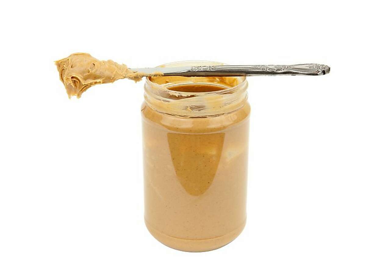 clip art of peanut butter for the H&G story on plants that smell like common foods. Open jar of peanut butter and knife, ready to spread. Isolated on white. Ran on: 02-22-2009 Ran on: 03-15-2009 Ran on: 03-15-2009
