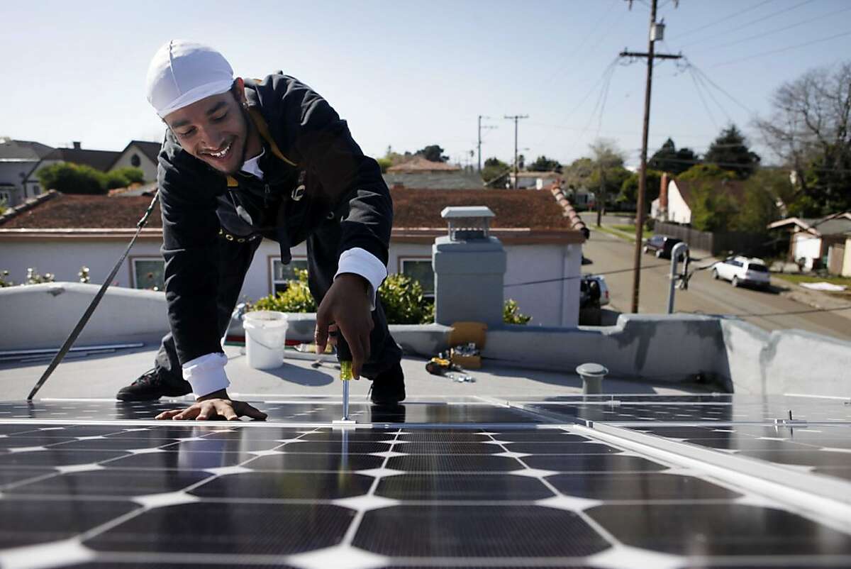 As part of an on-the-job training program in conjunction with groSolar, Clifton Broussard, 20, tightens the bolts on a new solar panel array that he helped install on a residential rooftop on Monday March 22, 2010 in Richmond, Calif. Part of the money for the training is coming from the home owner's own pocket who agreed that his $112 portion of the training could be a good investment in Broussard's future. Ran on: 04-21-2011 In a training program with groSolar last spring, Clifton Broussard works on a home in Richmond.
